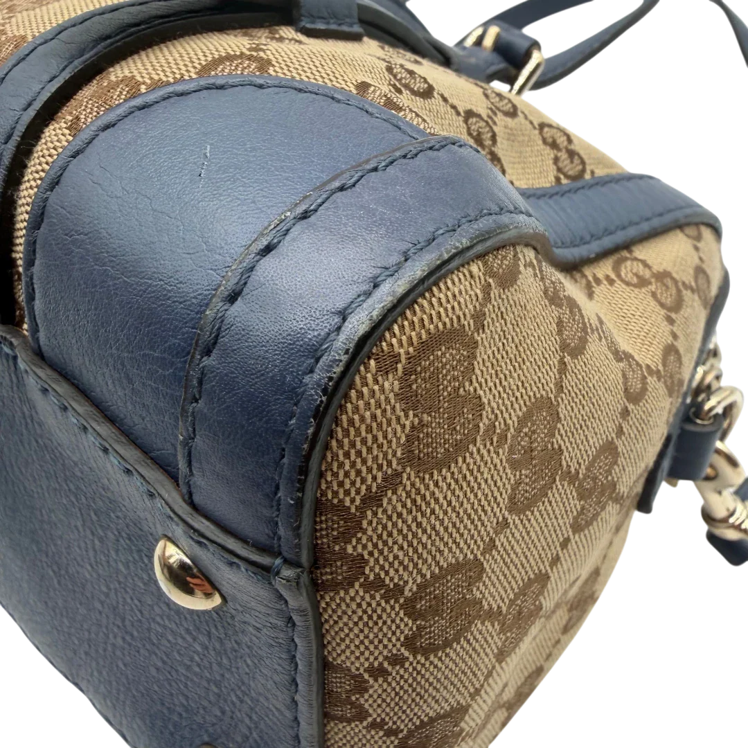 https://cdn.shopify.com/s/files/1/0564/9376/8855/files/Gucci_Handtasche_Boston_mit_Umhangegurt_monogram_beige_vintage_GG8601.webp?v=1781107385