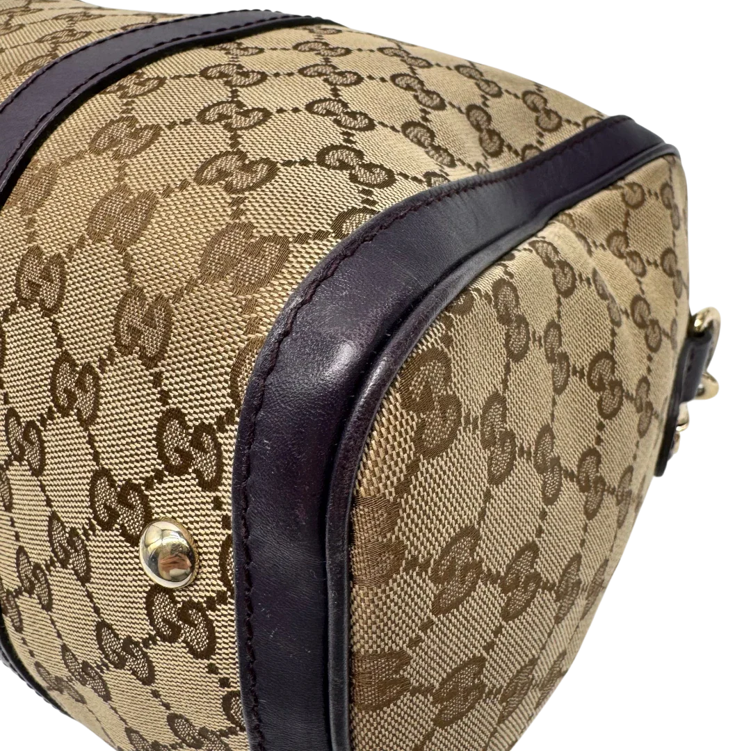 https://cdn.shopify.com/s/files/1/0564/9376/8855/files/Gucci_Handtasche_Boston_mit_Umhangegurt_monogram_beige_vintage_GG9943.webp?v=1775725815