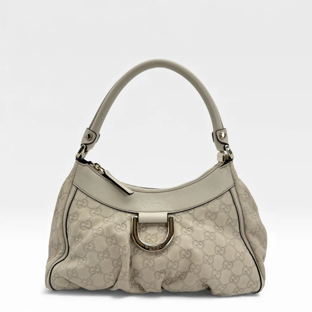https://cdn.shopify.com/s/files/1/0564/9376/8855/files/Gucci_Handtasche_D-Ring_aus_Leder_monogram_creme___beige_vintage_GG_handbag_5268.webp?v=1765385901