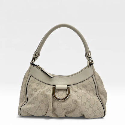 https://cdn.shopify.com/s/files/1/0564/9376/8855/files/Gucci_Handtasche_D-Ring_aus_Leder_monogram_creme___beige_vintage_GG_handbag_5268.webp?v=1765385901