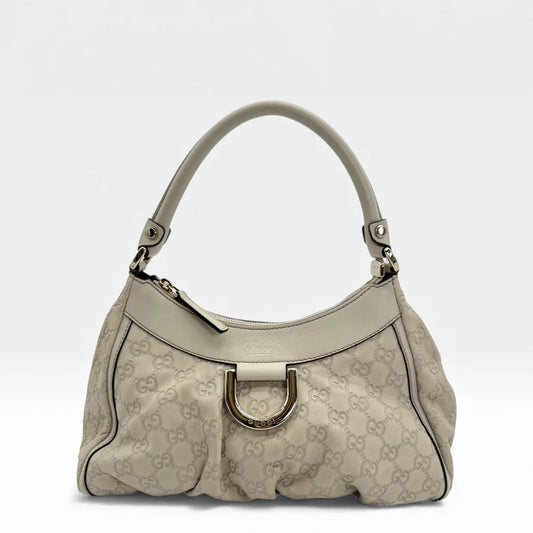 https://cdn.shopify.com/s/files/1/0564/9376/8855/files/Gucci_Handtasche_D-Ring_aus_Leder_monogram_creme___beige_vintage_GG_handbag_5268.webp?v=1765385901