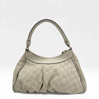 https://cdn.shopify.com/s/files/1/0564/9376/8855/files/Gucci_Handtasche_D-Ring_aus_Leder_monogram_creme___beige_vintage_GG_handbag_5269.webp?v=1765385915