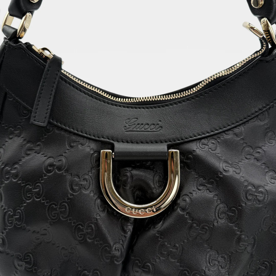 https://cdn.shopify.com/s/files/1/0564/9376/8855/files/Gucci_Handtasche_D-Ring_aus_Leder_monogram_schwarz_vintage_GG_handbag_5261.webp?v=1765382291