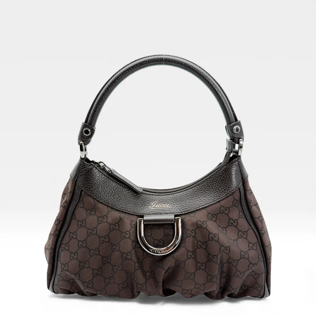 https://cdn.shopify.com/s/files/1/0564/9376/8855/files/Gucci_Handtasche_D-Ring_aus_Nylon_monogram_dunkelbraun_vintage_GG_handbag_5285.webp?v=1765384294