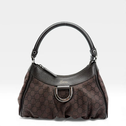 https://cdn.shopify.com/s/files/1/0564/9376/8855/files/Gucci_Handtasche_D-Ring_aus_Nylon_monogram_dunkelbraun_vintage_GG_handbag_5285.webp?v=1765384294