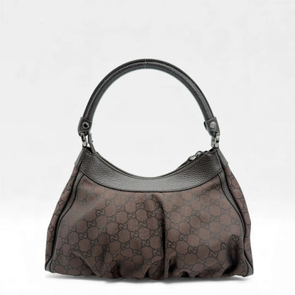 https://cdn.shopify.com/s/files/1/0564/9376/8855/files/Gucci_Handtasche_D-Ring_aus_Nylon_monogram_dunkelbraun_vintage_GG_handbag_5286.webp?v=1765384494