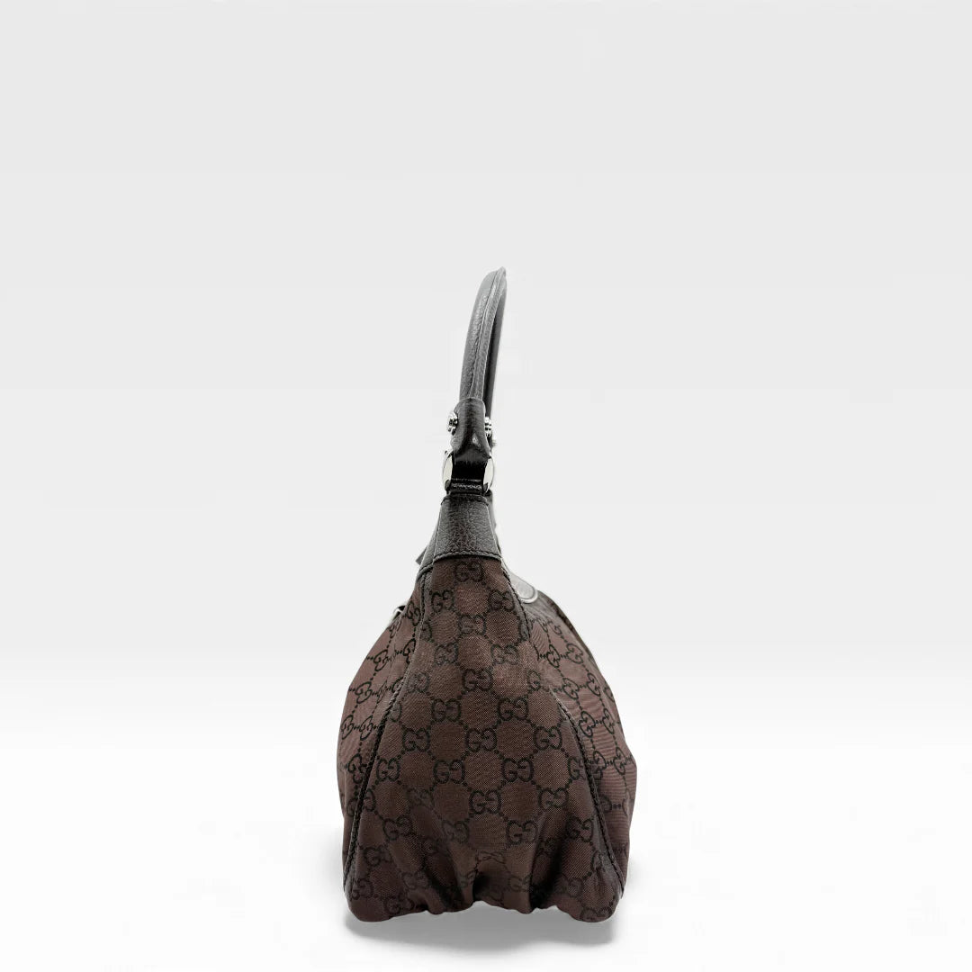 https://cdn.shopify.com/s/files/1/0564/9376/8855/files/Gucci_Handtasche_D-Ring_aus_Nylon_monogram_dunkelbraun_vintage_GG_handbag_5288.webp?v=1765384494