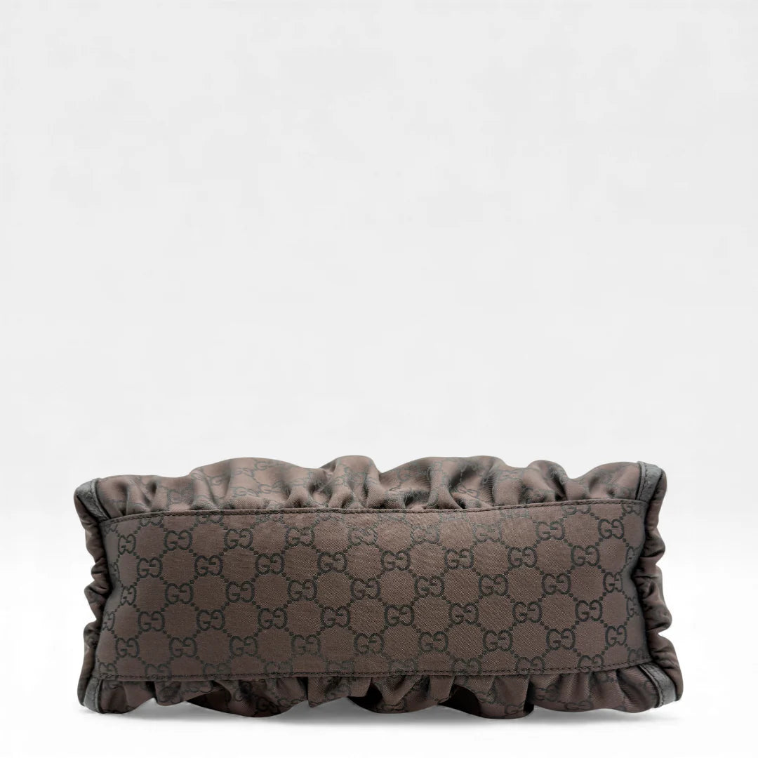 https://cdn.shopify.com/s/files/1/0564/9376/8855/files/Gucci_Handtasche_D-Ring_aus_Nylon_monogram_dunkelbraun_vintage_GG_handbag_5289.webp?v=1765384494