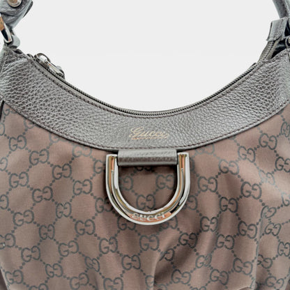 https://cdn.shopify.com/s/files/1/0564/9376/8855/files/Gucci_Handtasche_D-Ring_aus_Nylon_monogram_dunkelbraun_vintage_GG_handbag_5298.webp?v=1765384494