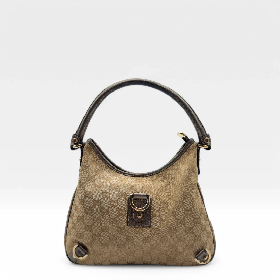 https://cdn.shopify.com/s/files/1/0564/9376/8855/files/Gucci_Handtasche_D-Ring_khaki_Lederdetails_monogram_beige_second_hand_luxury_GG_handbag_8404.webp?v=1741950473
