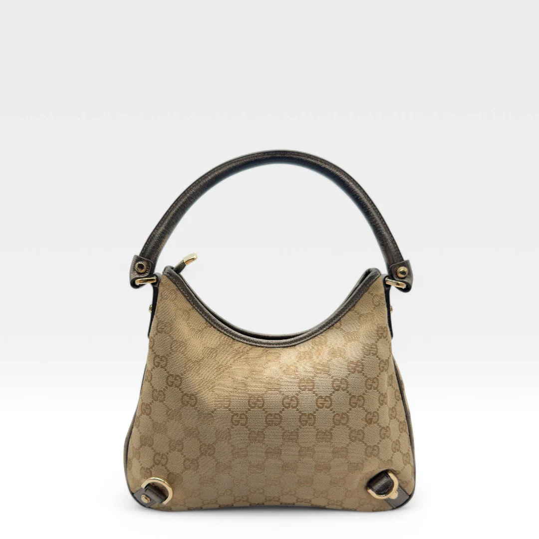 https://cdn.shopify.com/s/files/1/0564/9376/8855/files/Gucci_Handtasche_D-Ring_khaki_Lederdetails_monogram_beige_second_hand_luxury_GG_handbag_8405.webp?v=1741950500