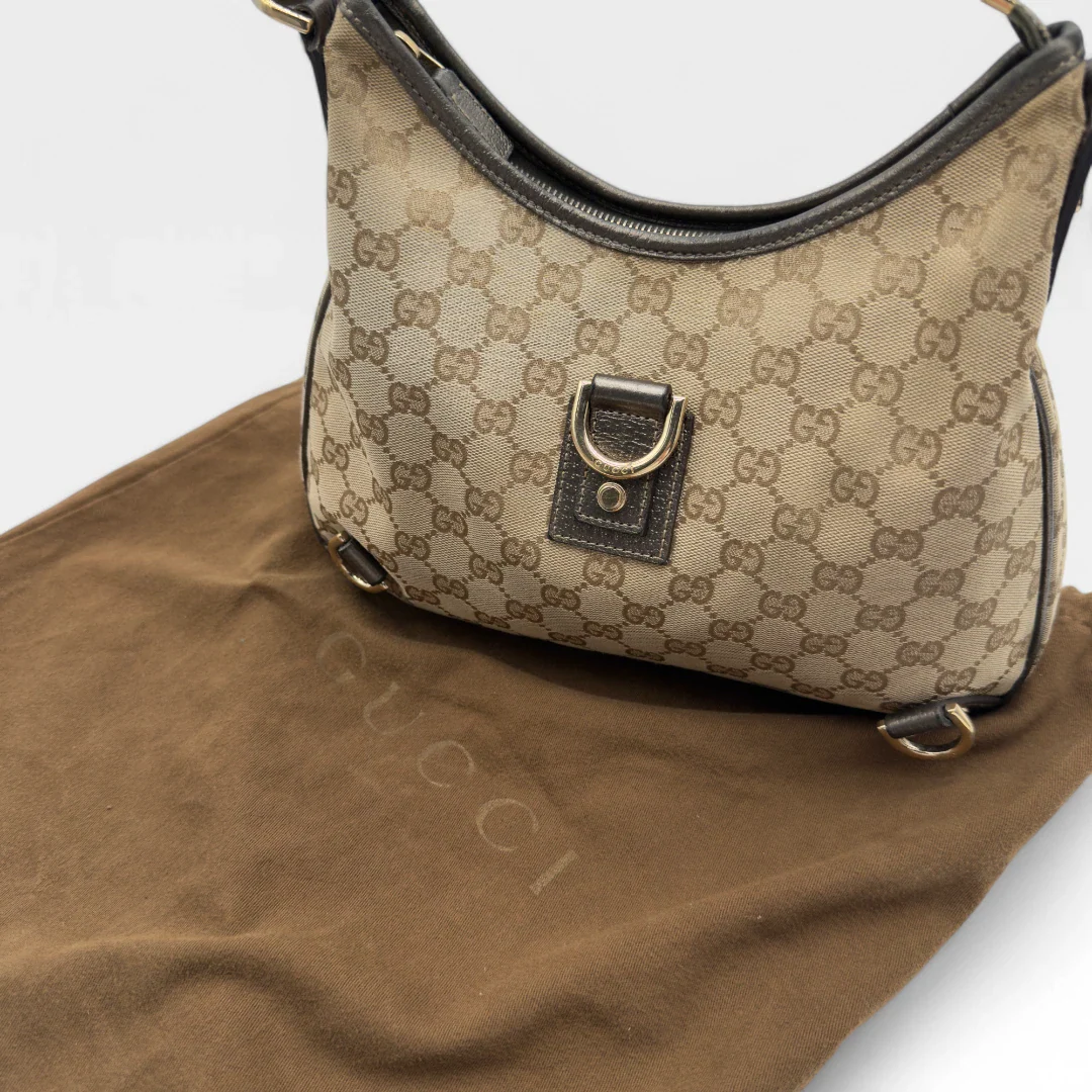 https://cdn.shopify.com/s/files/1/0564/9376/8855/files/Gucci_Handtasche_D-Ring_khaki_Lederdetails_monogram_beige_second_hand_luxury_GG_handbag_8435.webp?v=1741950500