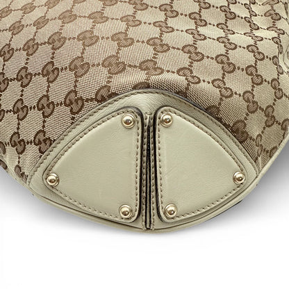 https://cdn.shopify.com/s/files/1/0564/9376/8855/files/Gucci_Handtasche_Indy_mit_Umhaengegurt_monogram_beige_vintage_GG_8646.webp?v=1768480310