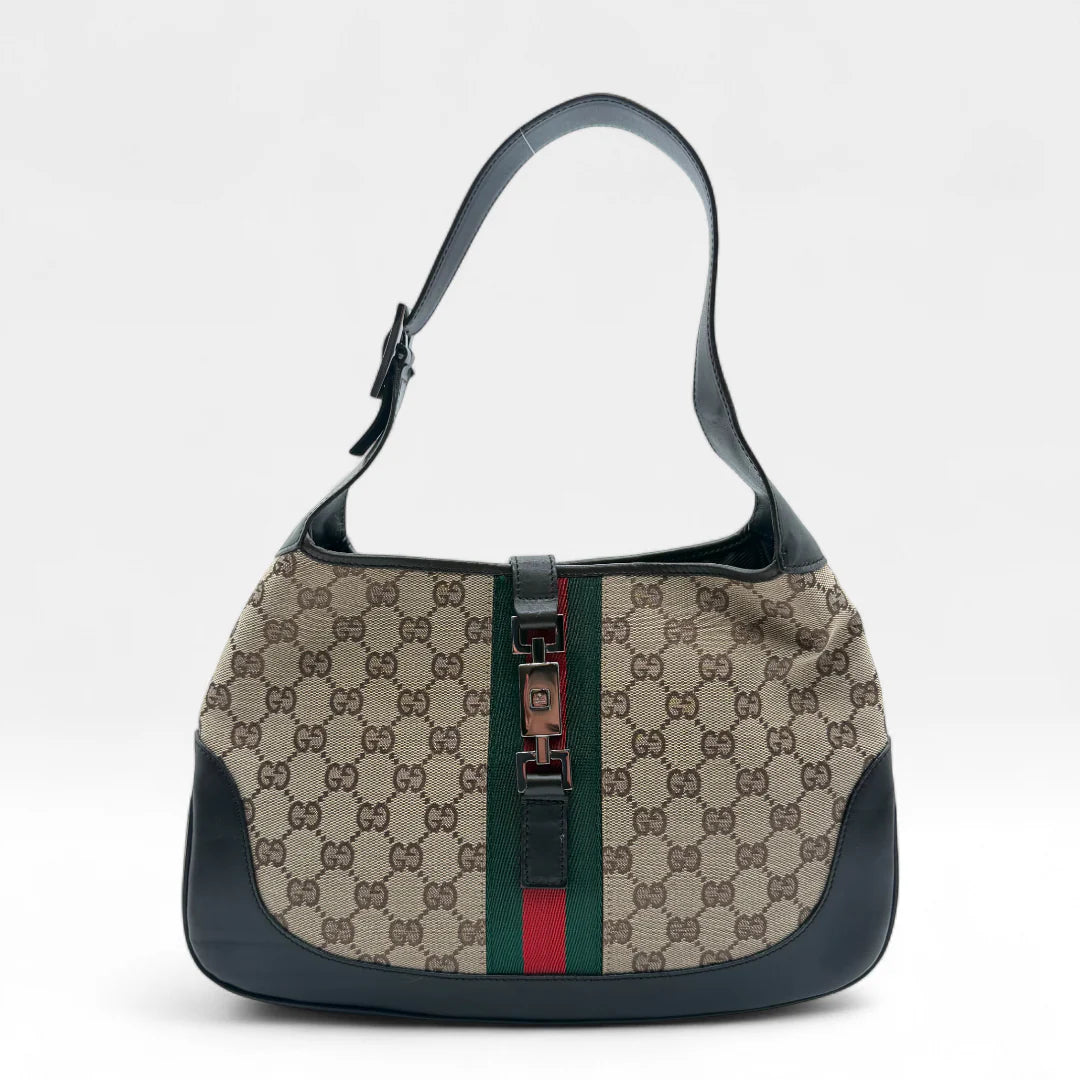 https://cdn.shopify.com/s/files/1/0564/9376/8855/files/Gucci_Handtasche_Jackie_Sherry_Line_monogram_beige_vintage_GG_handbag0297.webp?v=1760698365