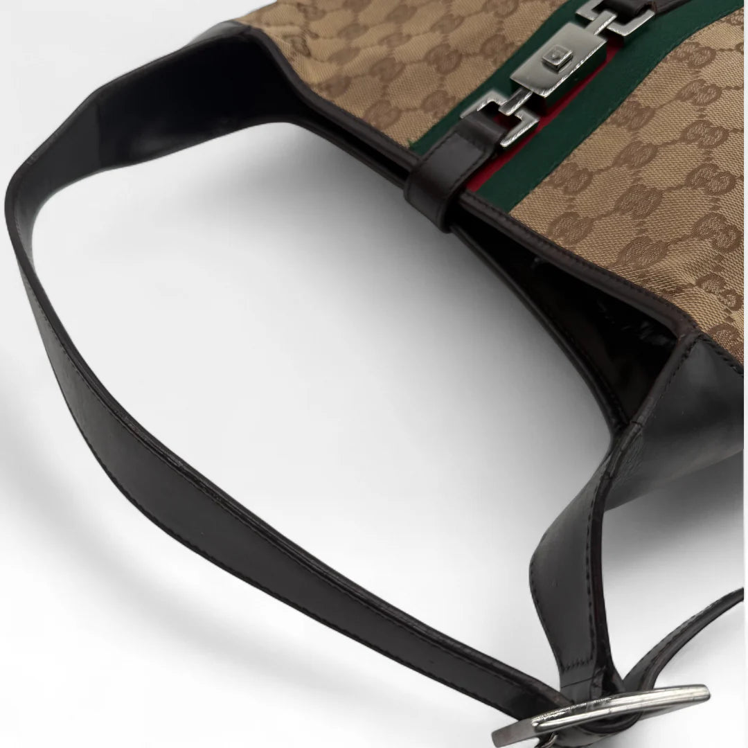 https://cdn.shopify.com/s/files/1/0564/9376/8855/files/Gucci_Handtasche_Jackie_Sherry_Line_monogram_beige_vintage_GG_handbag9492.webp?v=1760701865