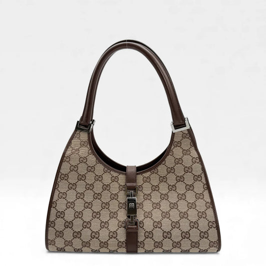 https://cdn.shopify.com/s/files/1/0564/9376/8855/files/Gucci_Handtasche_Jackie_monogram_beige_vintage_GG_handbag_5304.webp?v=1765384605