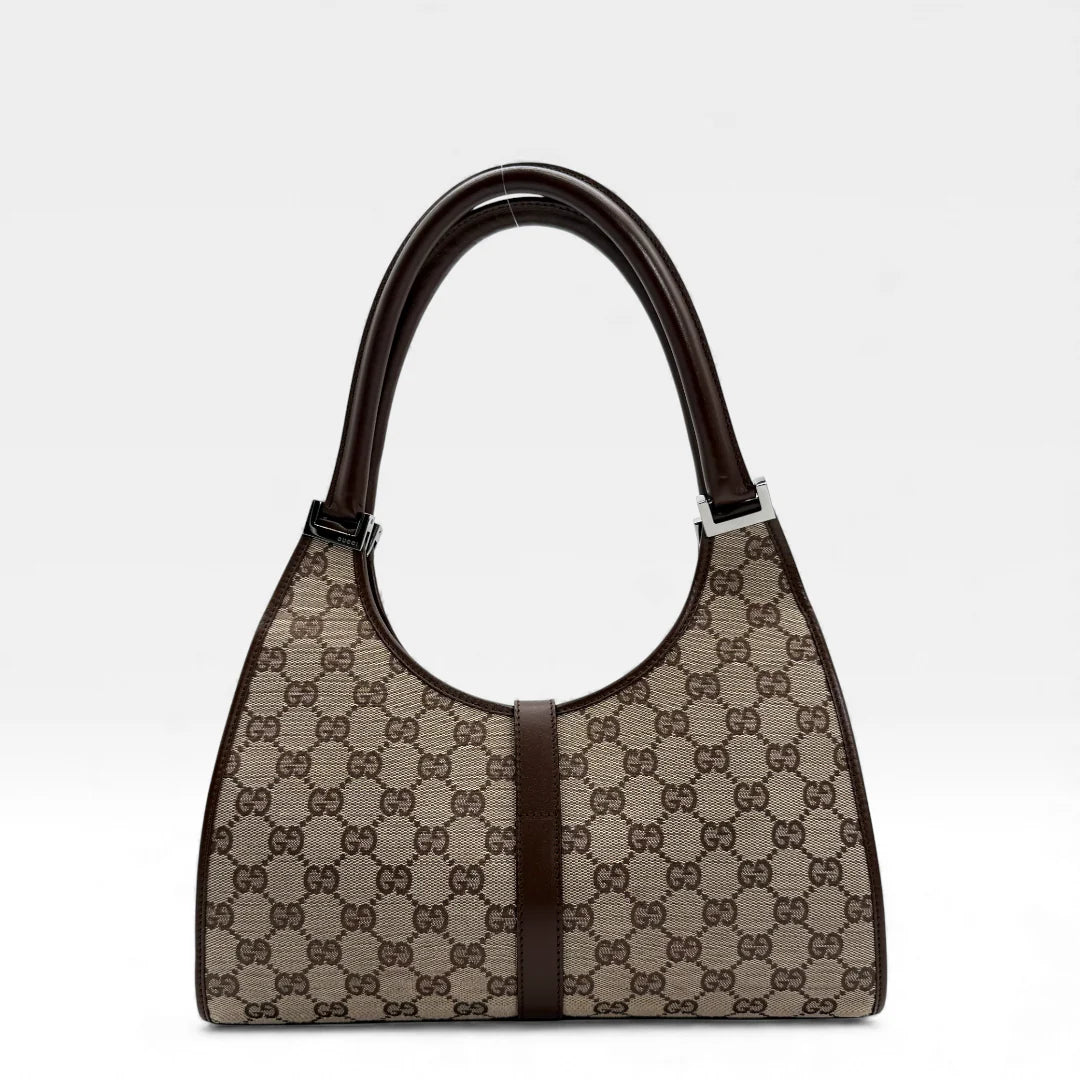https://cdn.shopify.com/s/files/1/0564/9376/8855/files/Gucci_Handtasche_Jackie_monogram_beige_vintage_GG_handbag_5305.webp?v=1765384622
