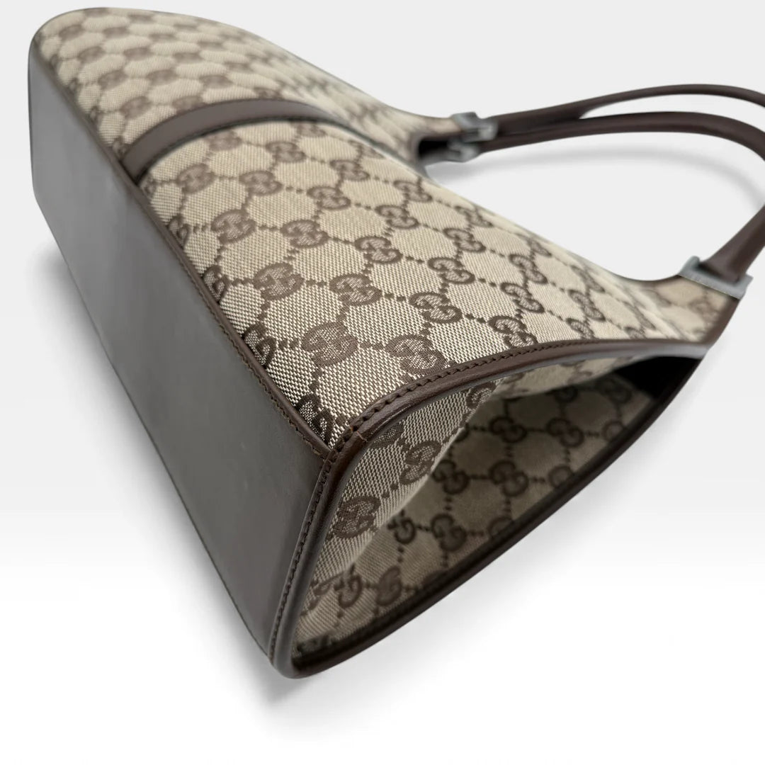 https://cdn.shopify.com/s/files/1/0564/9376/8855/files/Gucci_Handtasche_Jackie_monogram_beige_vintage_GG_handbag_5311.webp?v=1765384622
