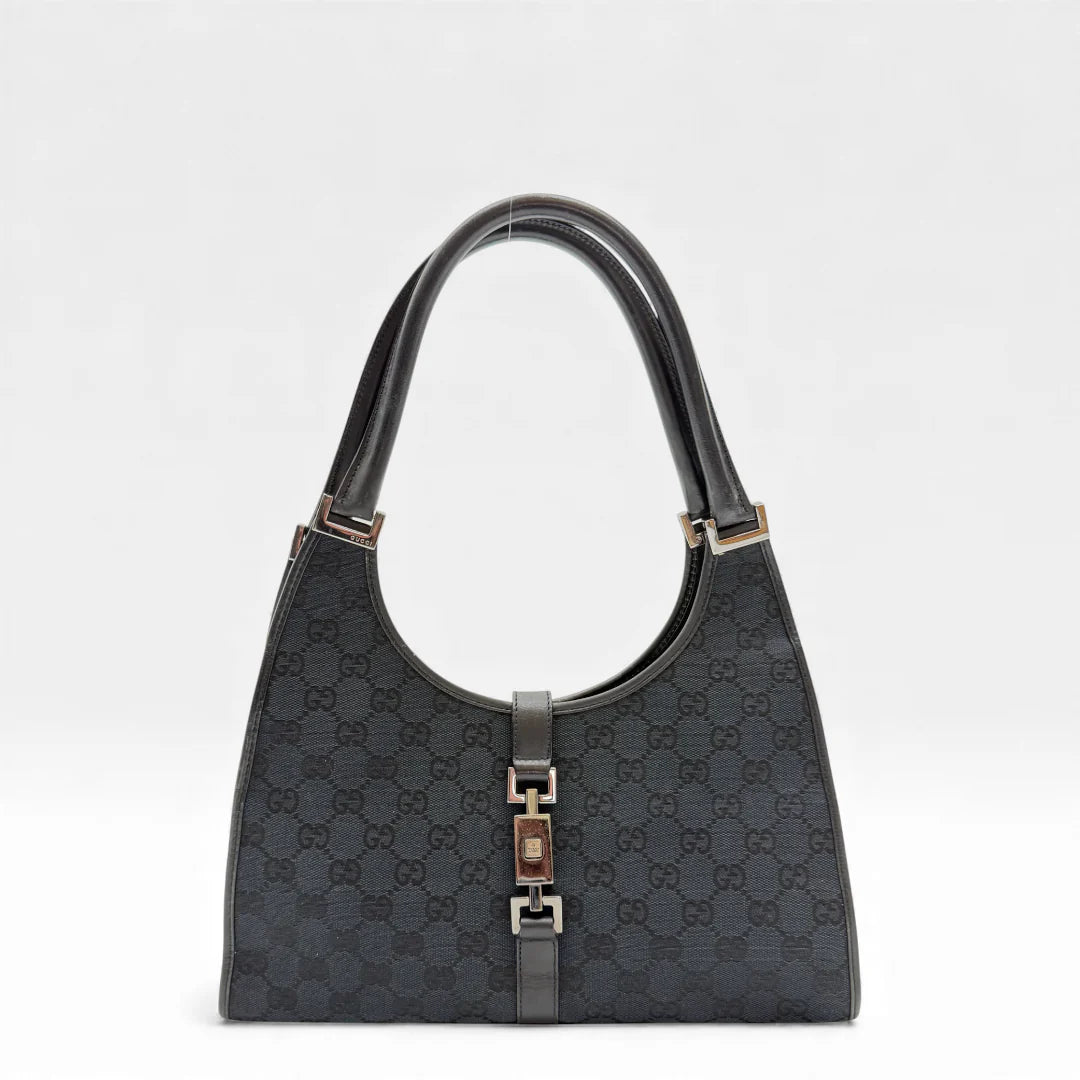 https://cdn.shopify.com/s/files/1/0564/9376/8855/files/Gucci_Handtasche_Jackie_monogram_schwarz_vintage_GG_handbag_4348.webp?v=1765387046