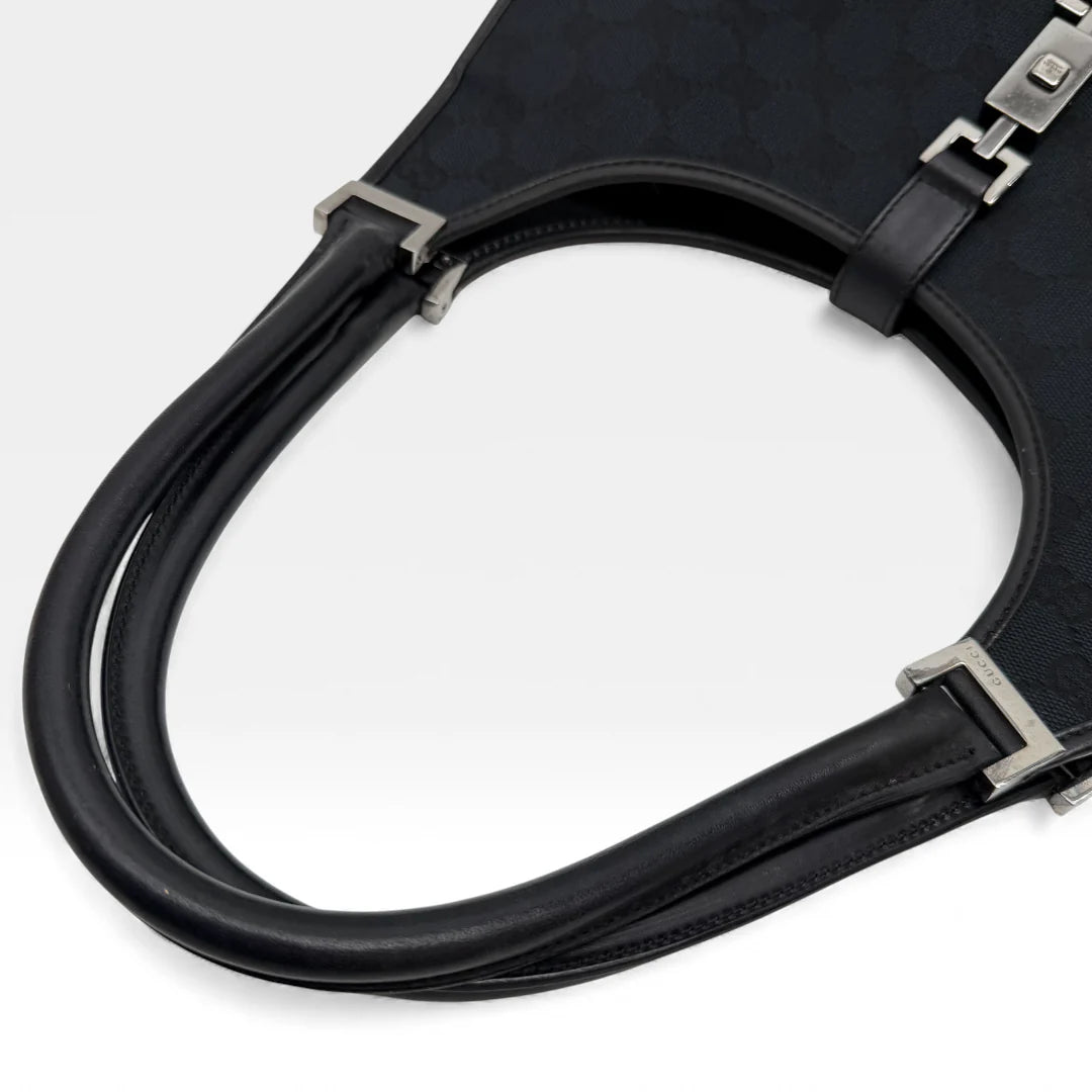 https://cdn.shopify.com/s/files/1/0564/9376/8855/files/Gucci_Handtasche_Jackie_monogram_schwarz_vintage_GG_handbag_4360.webp?v=1765387051