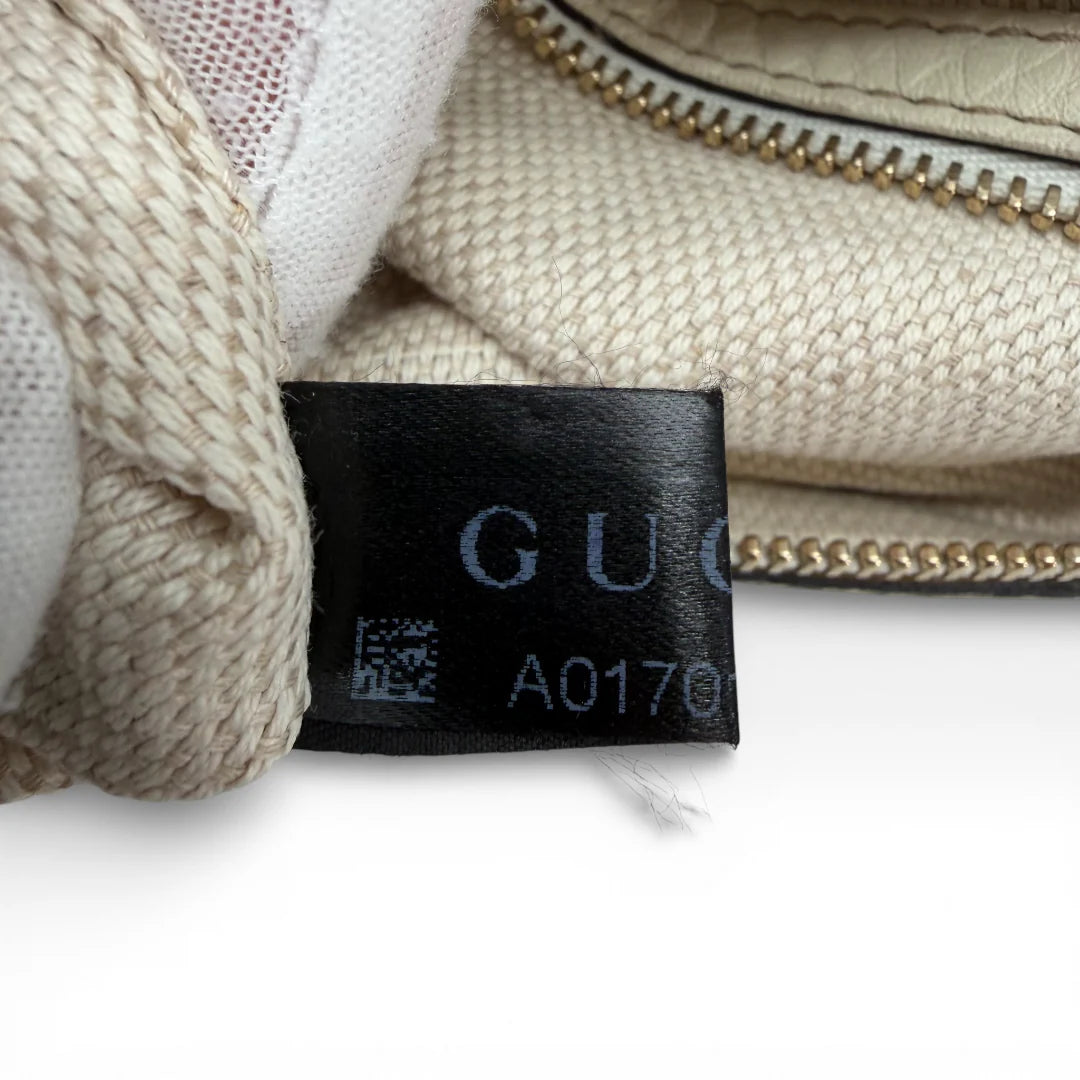 https://cdn.shopify.com/s/files/1/0564/9376/8855/files/Gucci_Handtasche_Soho_mit_Umhangegurt_aus_Leder_weiss_vintage_6742.webp?v=1767727612