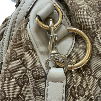 https://cdn.shopify.com/s/files/1/0564/9376/8855/files/Gucci_Handtasche_Sukey_mit_Umhangegurt_monogram_beige_13_0f1951ee-7da7-47d9-b6e9-7f51e9b2a74b.webp?v=1783513327