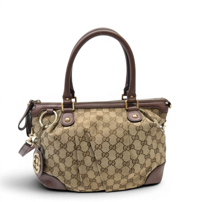 https://cdn.shopify.com/s/files/1/0564/9376/8855/files/Gucci_Handtasche_Sukey_mit_Umhangegurt_monogram_beige_1_3657bbd8-381b-4553-9059-b73410a81f79.webp?v=1783513163