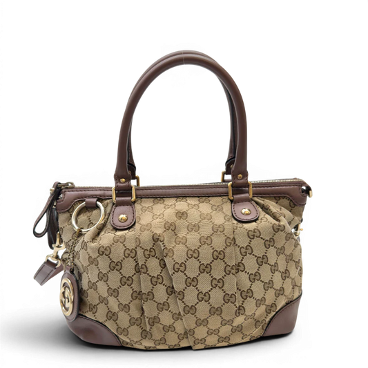 https://cdn.shopify.com/s/files/1/0564/9376/8855/files/Gucci_Handtasche_Sukey_mit_Umhangegurt_monogram_beige_1_3657bbd8-381b-4553-9059-b73410a81f79.webp?v=1783513163