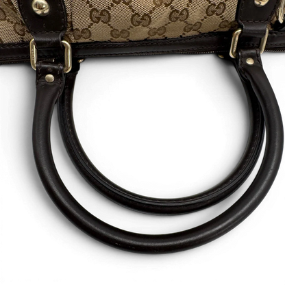 https://cdn.shopify.com/s/files/1/0564/9376/8855/files/Gucci_Handtasche_Sukey_mit_Umhangegurt_monogram_beige_vintage_GG2333.webp?v=1779968392