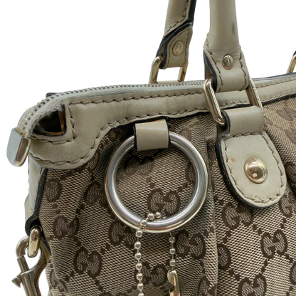 https://cdn.shopify.com/s/files/1/0564/9376/8855/files/Gucci_Handtasche_Sukey_mit_Umhangegurt_monogram_beige_vintage_GG7939.webp?v=1779966403