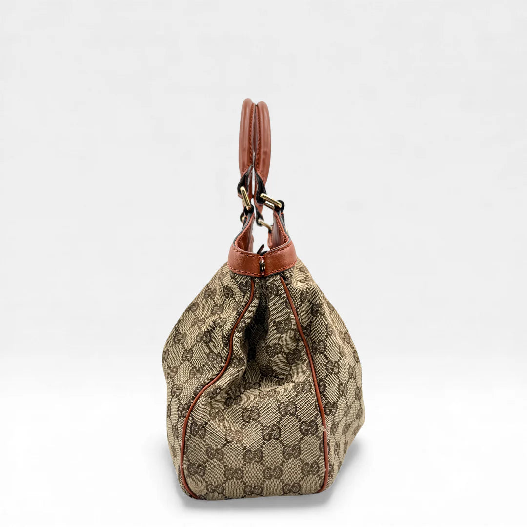 https://cdn.shopify.com/s/files/1/0564/9376/8855/files/Gucci_Handtasche_Sukey_monogram_beige_vintage_GG_handbag4960.webp?v=1764950994