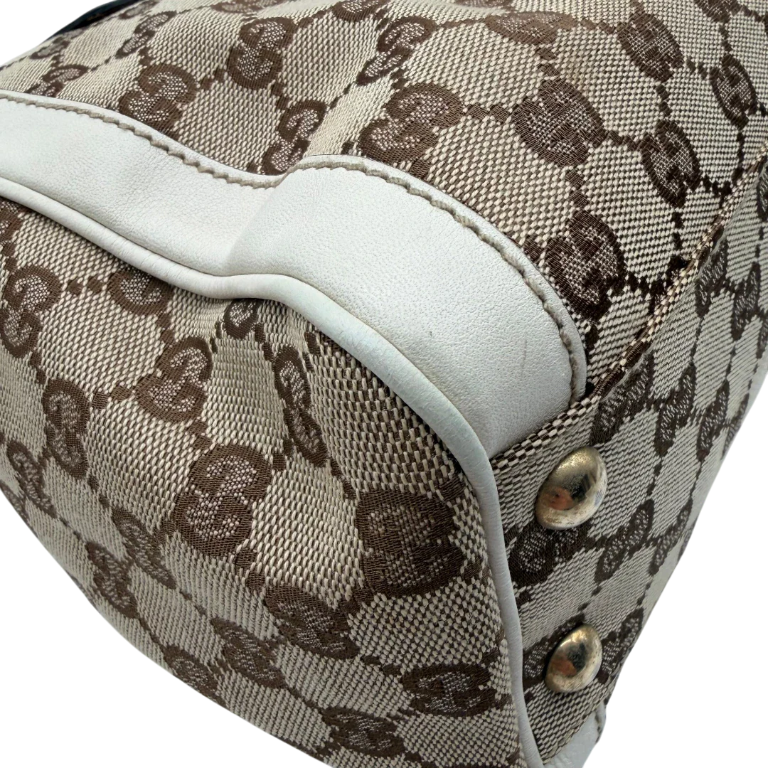 https://cdn.shopify.com/s/files/1/0564/9376/8855/files/Gucci_Handtasche_Trophy_mit_Gucci_Blume_beige_9.webp?v=1781713049