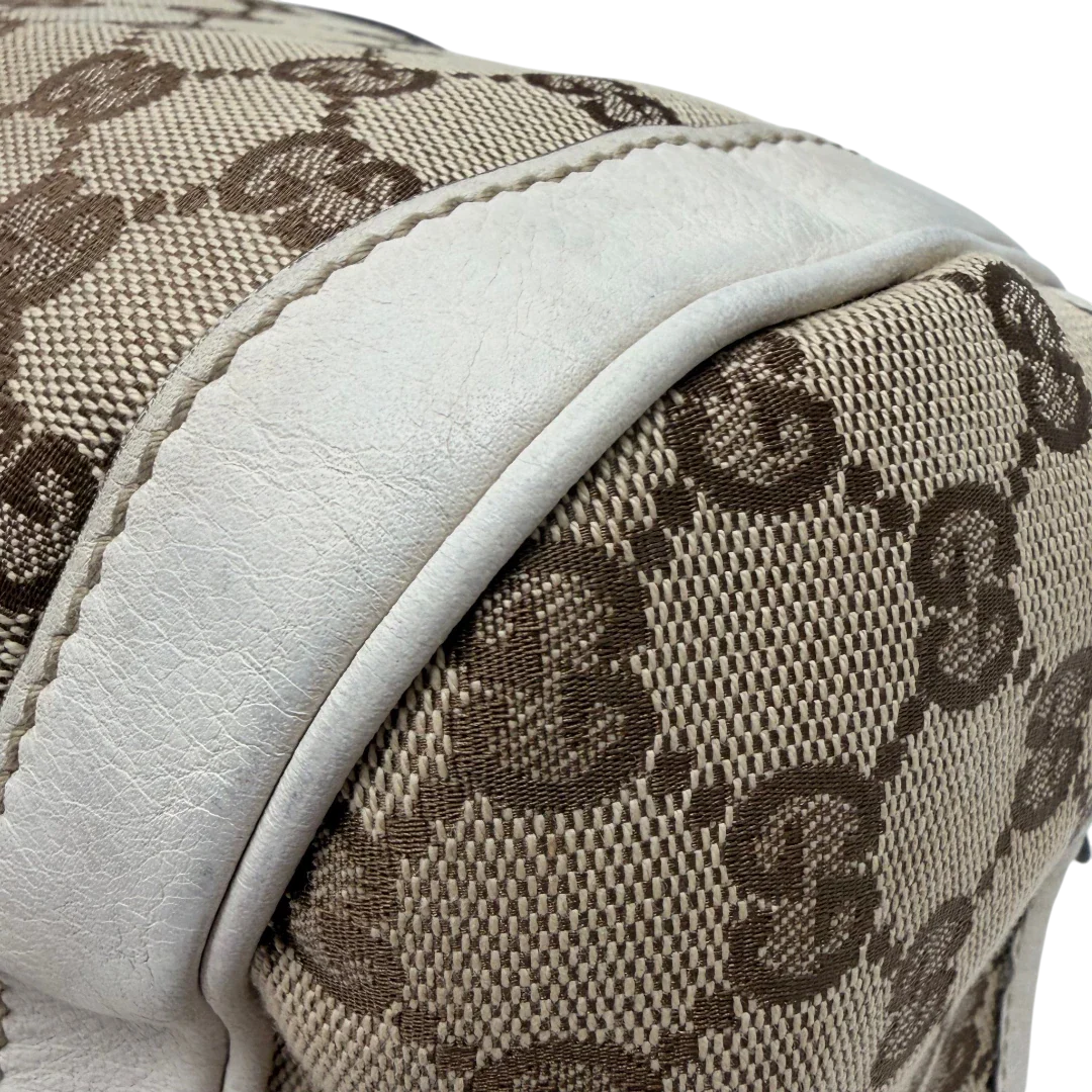 https://cdn.shopify.com/s/files/1/0564/9376/8855/files/Gucci_Handtasche_Zylinder_mit_Gucci_Blume_beige_vintage7856.webp?v=1780490138