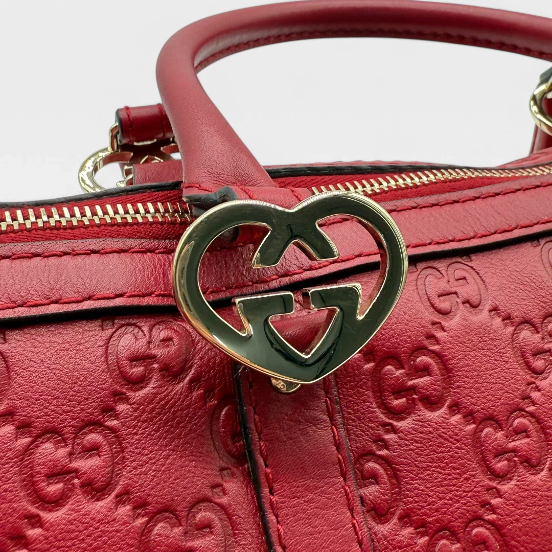 https://cdn.shopify.com/s/files/1/0564/9376/8855/files/Gucci_Handtasche_mit_Herz_Locks_aus_Leder_monogram_Rot_vintage_luxury_GG_handbag_2513.webp?v=1743624006