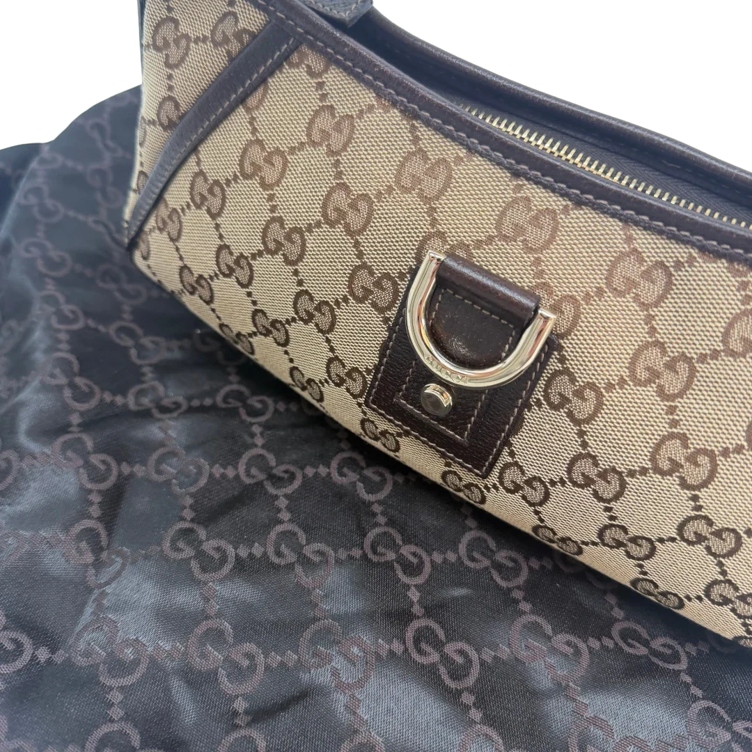 https://cdn.shopify.com/s/files/1/0564/9376/8855/files/Gucci_Pochette_Abbey_D-Ring_monogram_beige_vintage_GG6933.webp?v=1779325750