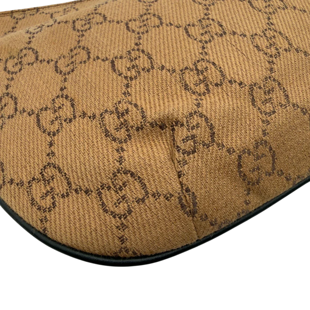 https://cdn.shopify.com/s/files/1/0564/9376/8855/files/Gucci_Pochette_Croissant_monogram_braun_vintage_GG7556.webp?v=1779319553