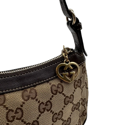 https://cdn.shopify.com/s/files/1/0564/9376/8855/files/Gucci_Pochette_Lovely_mit_GG_Herz_monogram_beige_12.webp?v=1783514912