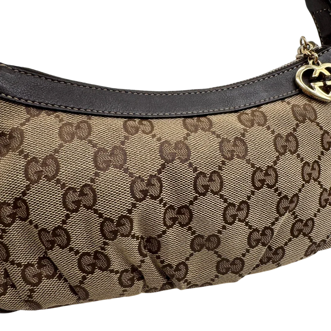 https://cdn.shopify.com/s/files/1/0564/9376/8855/files/Gucci_Pochette_Lovely_mit_GG_Herz_monogram_beige_14.webp?v=1783514913