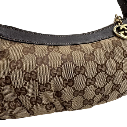 https://cdn.shopify.com/s/files/1/0564/9376/8855/files/Gucci_Pochette_Lovely_mit_GG_Herz_monogram_beige_14.webp?v=1783514913