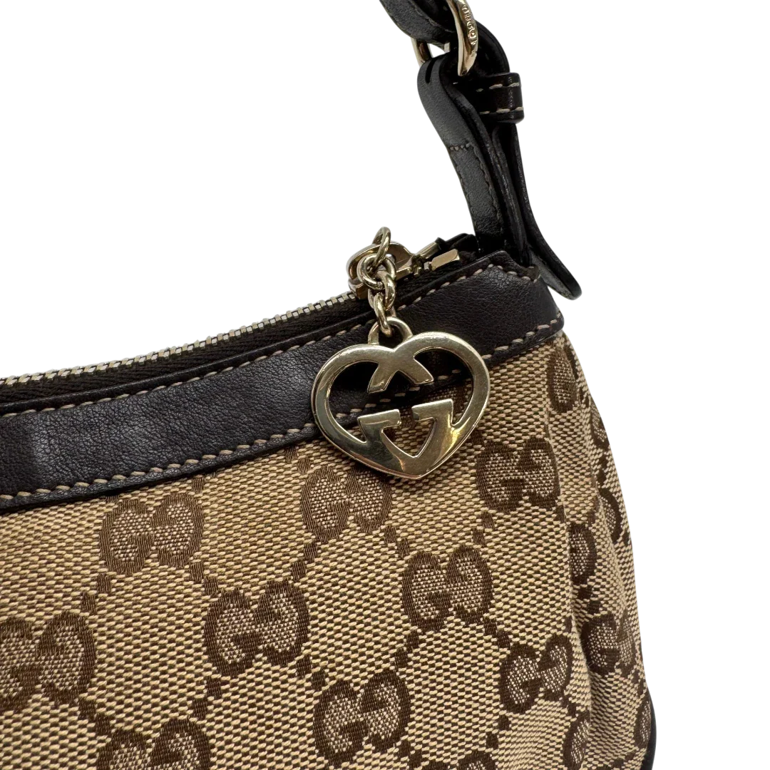 https://cdn.shopify.com/s/files/1/0564/9376/8855/files/Gucci_Pochette_Lovely_mit_GG_Herz_monogram_beige_vintage_GG2380.webp?v=1779966529