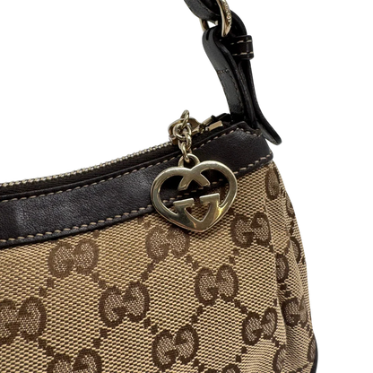 https://cdn.shopify.com/s/files/1/0564/9376/8855/files/Gucci_Pochette_Lovely_mit_GG_Herz_monogram_beige_vintage_GG2380.webp?v=1779966529