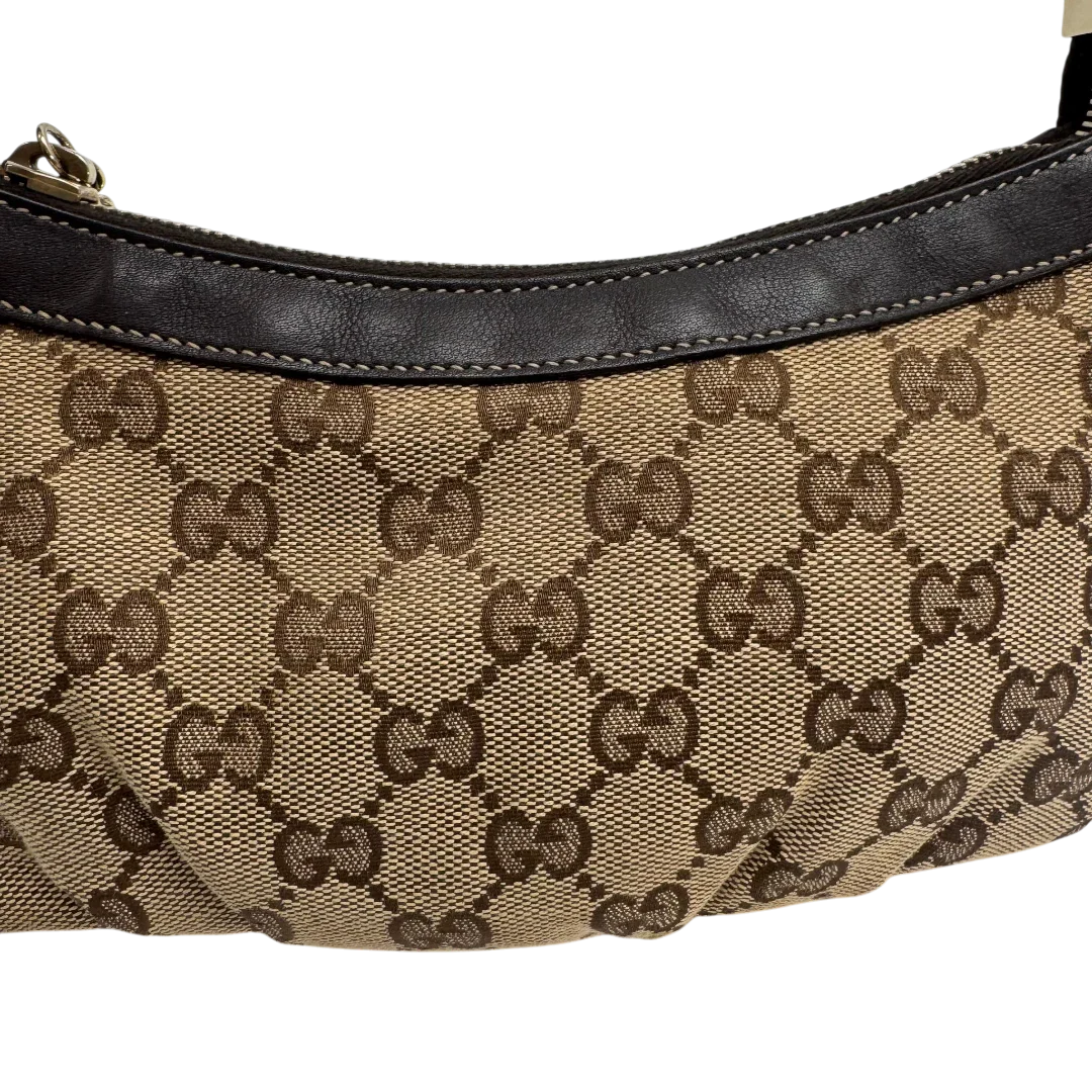 https://cdn.shopify.com/s/files/1/0564/9376/8855/files/Gucci_Pochette_Lovely_mit_GG_Herz_monogram_beige_vintage_GG2383.webp?v=1779966529