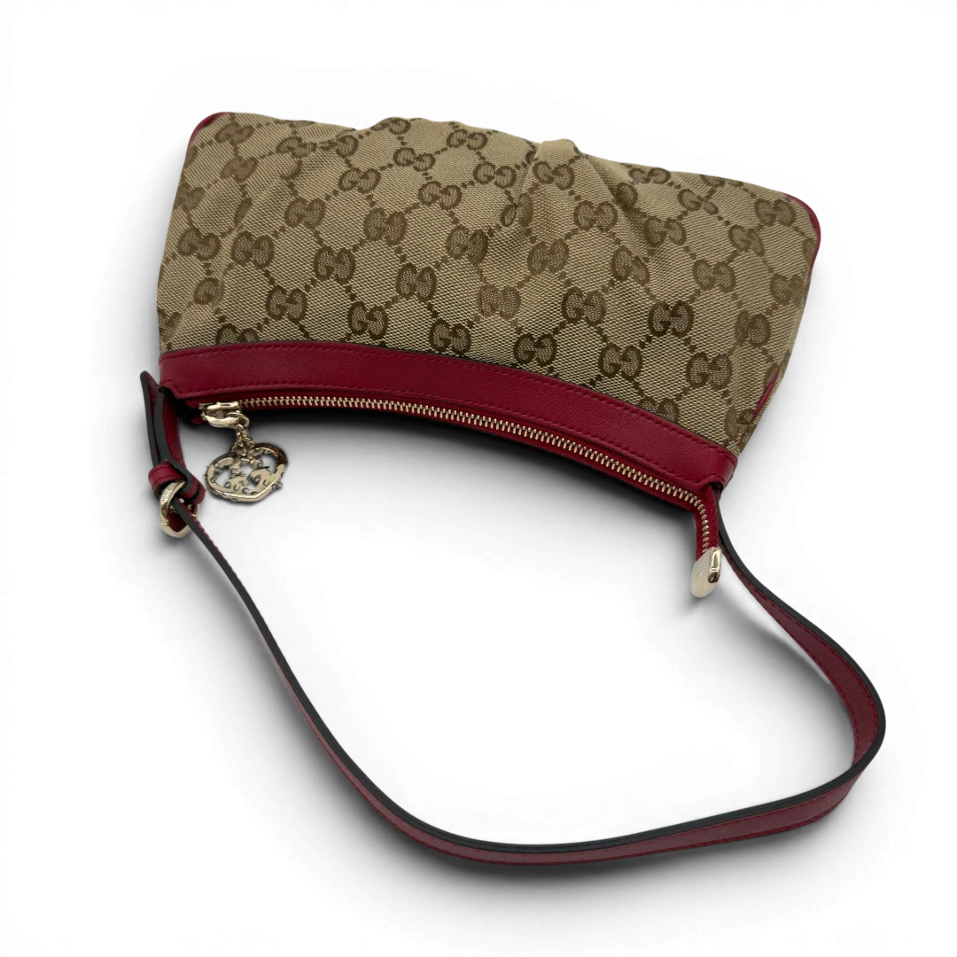 https://cdn.shopify.com/s/files/1/0564/9376/8855/files/Gucci_Pochette_Lovely_mit_GG_Herz_monogram_beige_vintage_GG7510.webp?v=1779286740