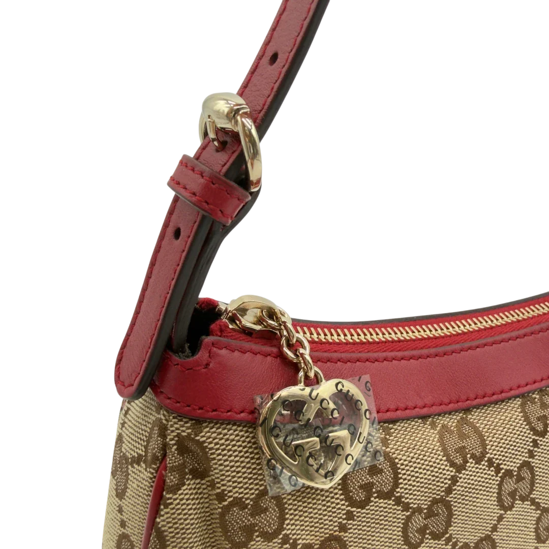 https://cdn.shopify.com/s/files/1/0564/9376/8855/files/Gucci_Pochette_Lovely_mit_GG_Herz_monogram_beige_vintage_GG7511.webp?v=1779286740