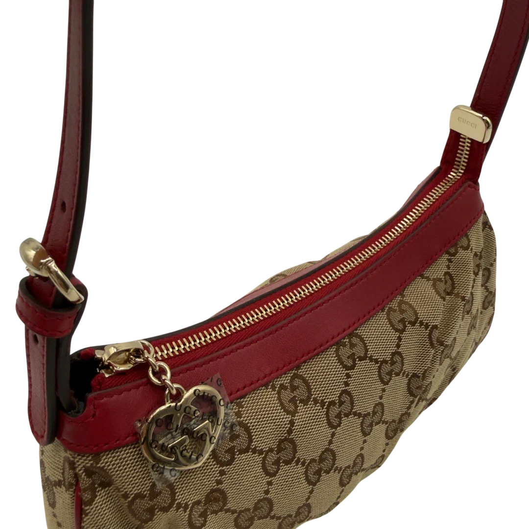 https://cdn.shopify.com/s/files/1/0564/9376/8855/files/Gucci_Pochette_Lovely_mit_GG_Herz_monogram_beige_vintage_GG7513.webp?v=1779286740