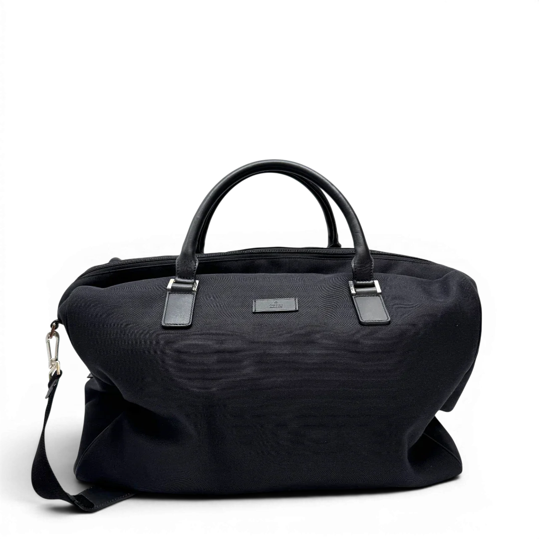 https://cdn.shopify.com/s/files/1/0564/9376/8855/files/Gucci_Reisetasche_50_mit_Umhangegurt_schwarz_1.webp?v=1784245416