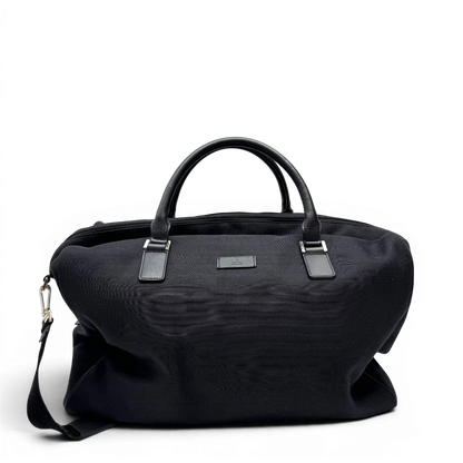 https://cdn.shopify.com/s/files/1/0564/9376/8855/files/Gucci_Reisetasche_50_mit_Umhangegurt_schwarz_1.webp?v=1784245416