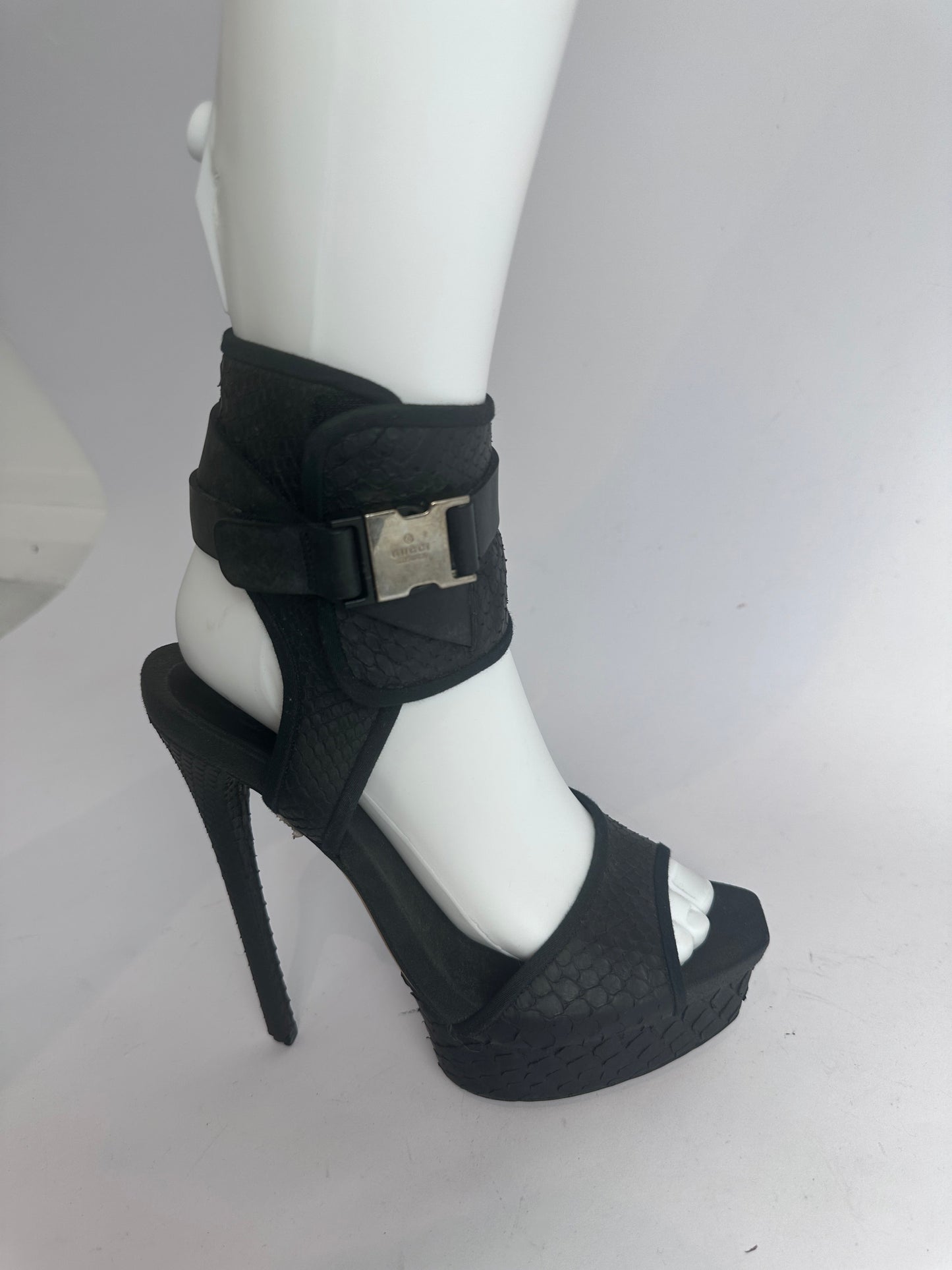 Platform heel with buckle detail on a white mannequin