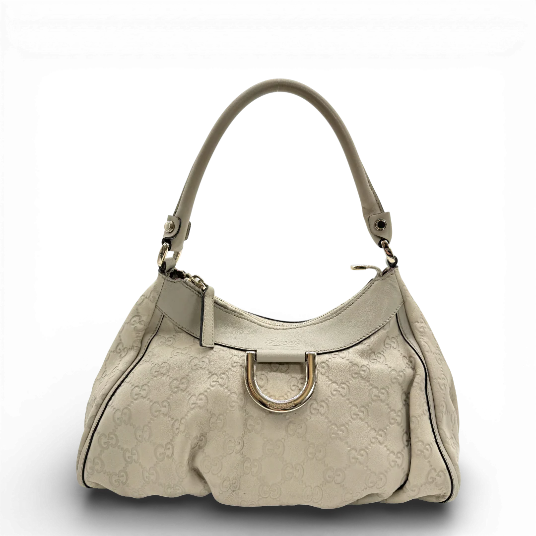 https://cdn.shopify.com/s/files/1/0564/9376/8855/files/Gucci_Schultertasche_D-Ring_aus_Leder_monogram_beige_vintage_GG_1400.webp?v=1771504355