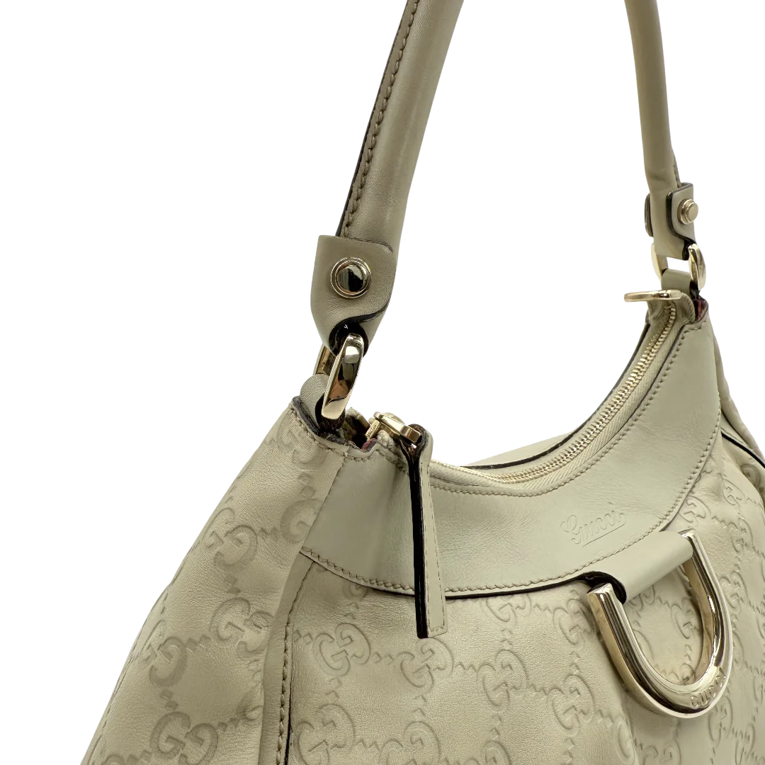 https://cdn.shopify.com/s/files/1/0564/9376/8855/files/Gucci_Schultertasche_D-Ring_aus_Leder_monogram_beige_vintage_GG_1411.webp?v=1771504409